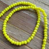 Streng facet rondellen imitatie jade geel 